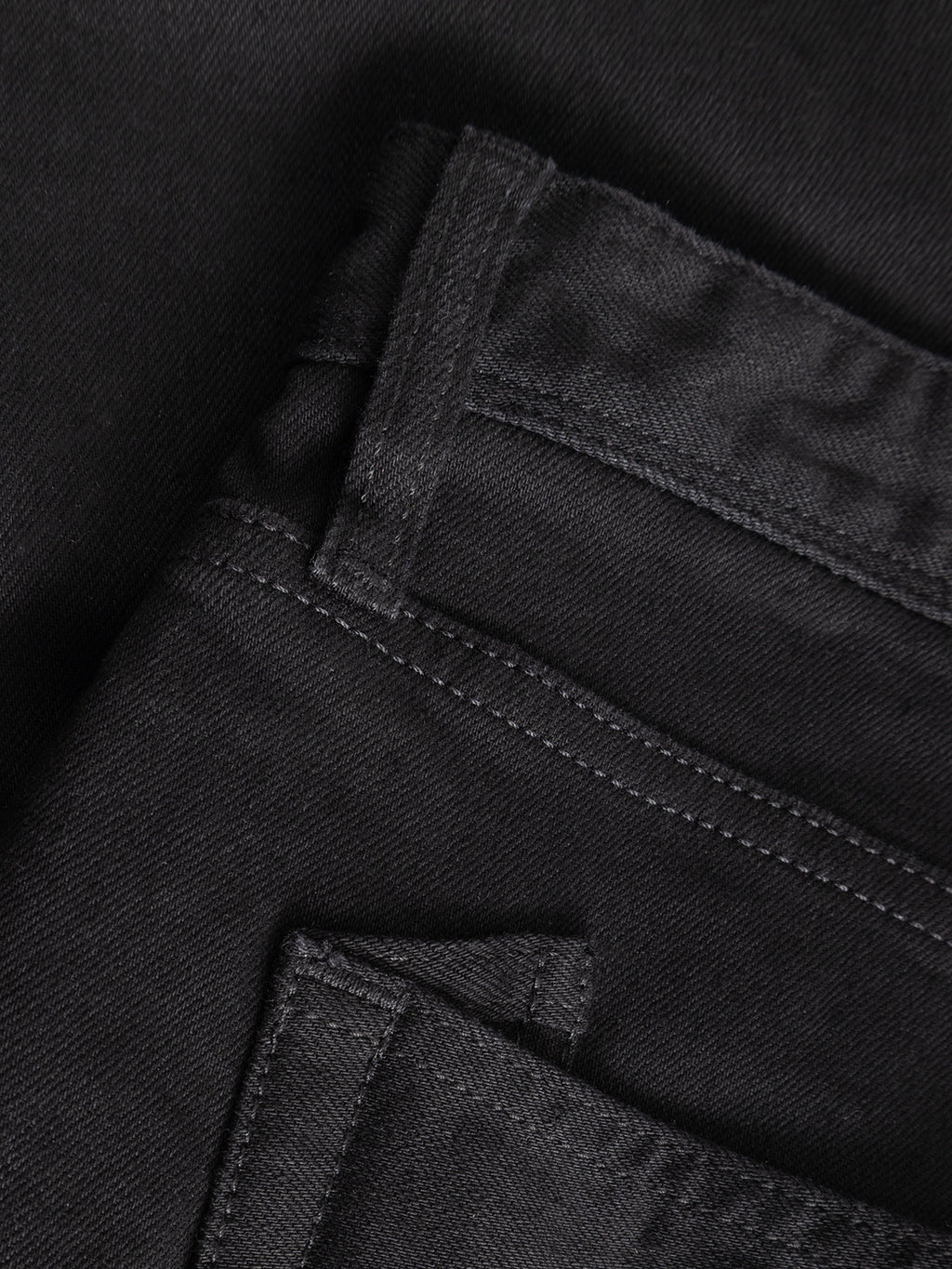Close-up of the Gabba GABsenna Black DS0006 Jeans in black denim, highlighting the front and back pockets, visible seams, and intricate stitching. Crafted from comfort stretch twill with a loose tapered fit and garment-dyed black finish, these jeans offer a relaxed yet refined look.