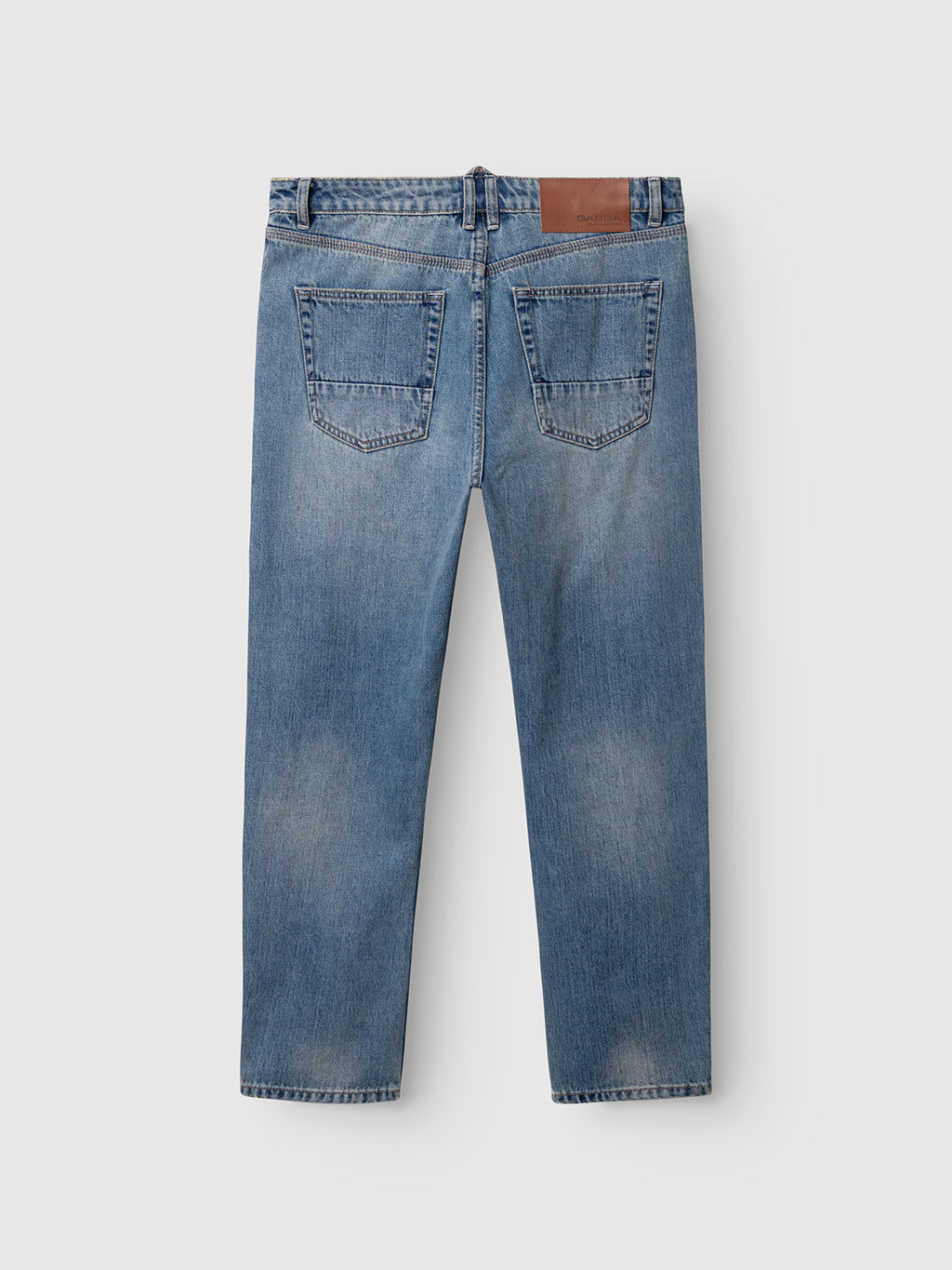 Back view of Gabba GABcarl Bieffe GW0001 Jeans in mid-blue denim, showcasing two rear pockets and a brown leather patch on the waistband, featuring a loose tapered fit and displayed flat on a white background.