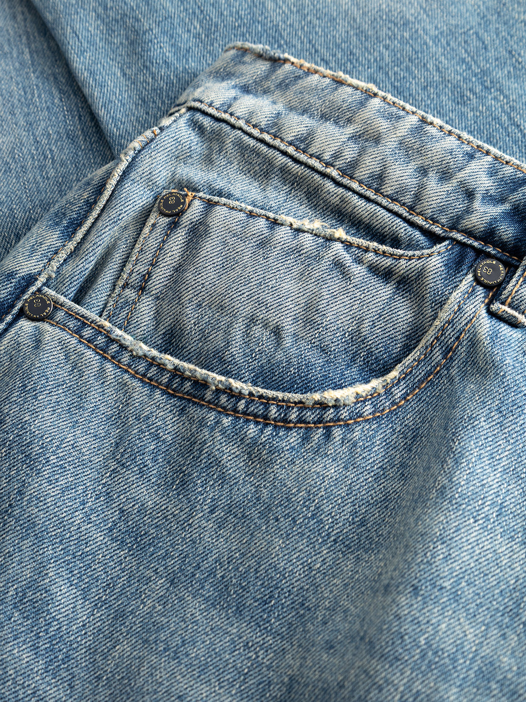 Close-up of the Gabba GABcarl Bieffe GW0001 Jeans in mid blue denim, highlighting the textured details of slub denim with visible stitching and rivets on the pocket.