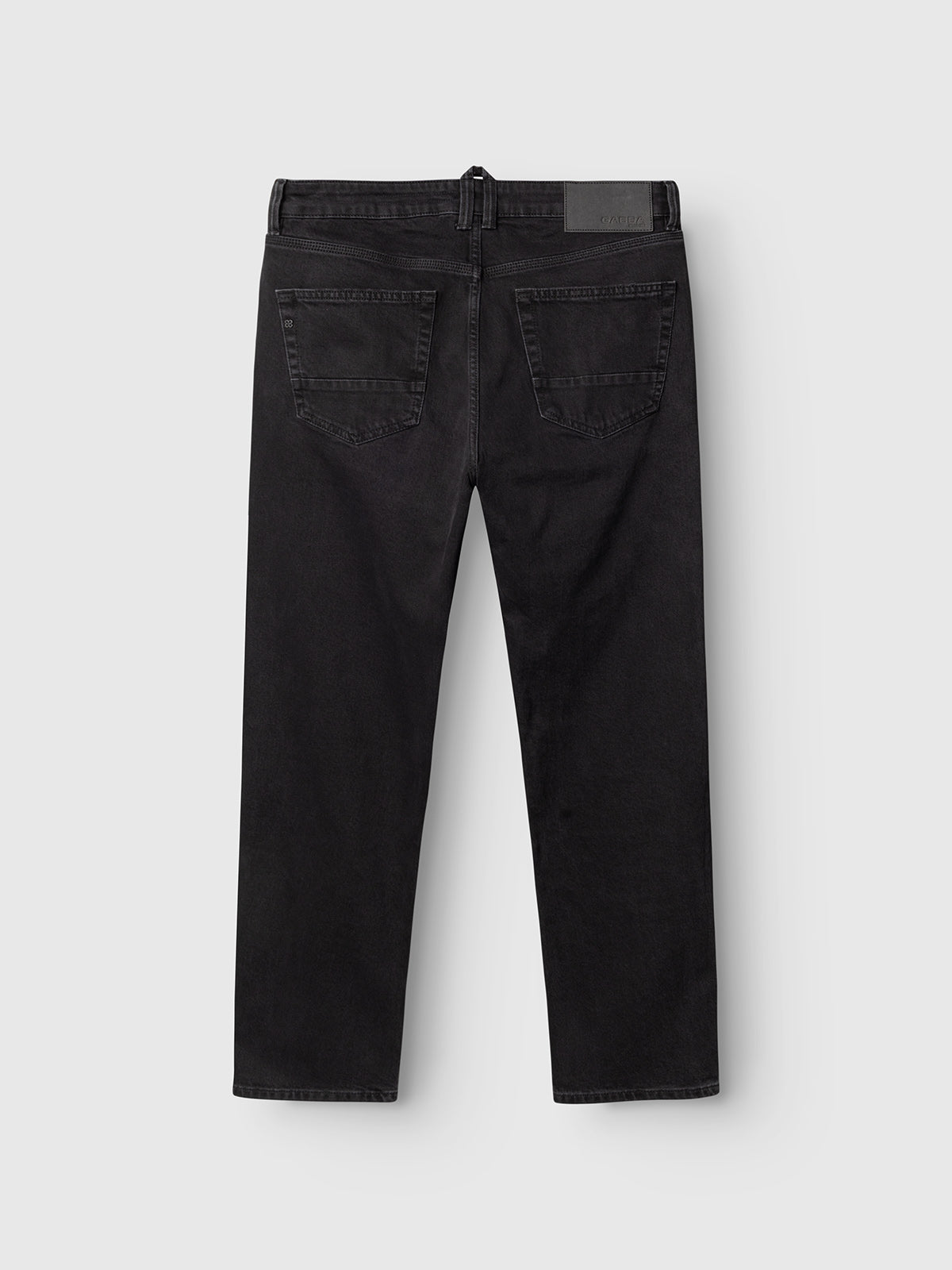 A pair of Gabba GABcarl Blaccom WW0035 Jeans in black denim is shown from the back, featuring two rear pockets and a black patch on the waistband, set against a plain white background.