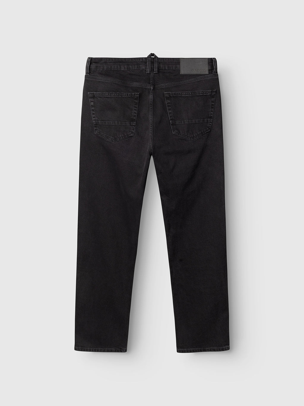 A pair of Gabba GABcarl Blaccom WW0035 Jeans in black denim is shown from the back, featuring two rear pockets and a black patch on the waistband, set against a plain white background.