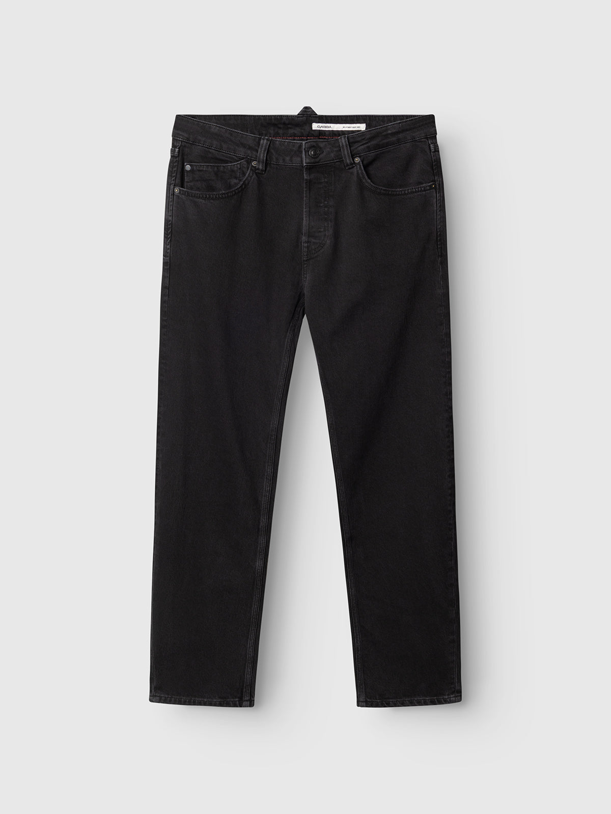 A pair of Gabba GABcarl Blaccom WW0035 Jeans in black denim laid flat on a light gray background, displayed from the front to showcase the pockets, belt loops, button closure, and loose tapered fit.
