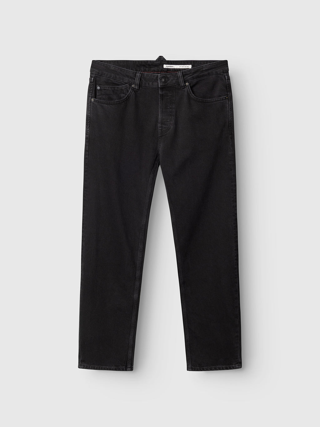 A pair of Gabba GABcarl Blaccom WW0035 Jeans in black denim laid flat on a light gray background, displayed from the front to showcase the pockets, belt loops, button closure, and loose tapered fit.