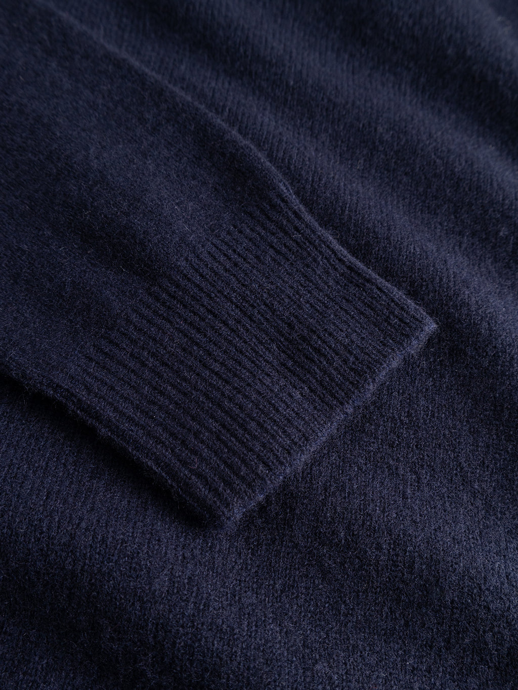 Close-up of the Gabba GABworren Polo Aico LS Knit in navy, highlighting the ribbed cuff and the soft, textured fabric.