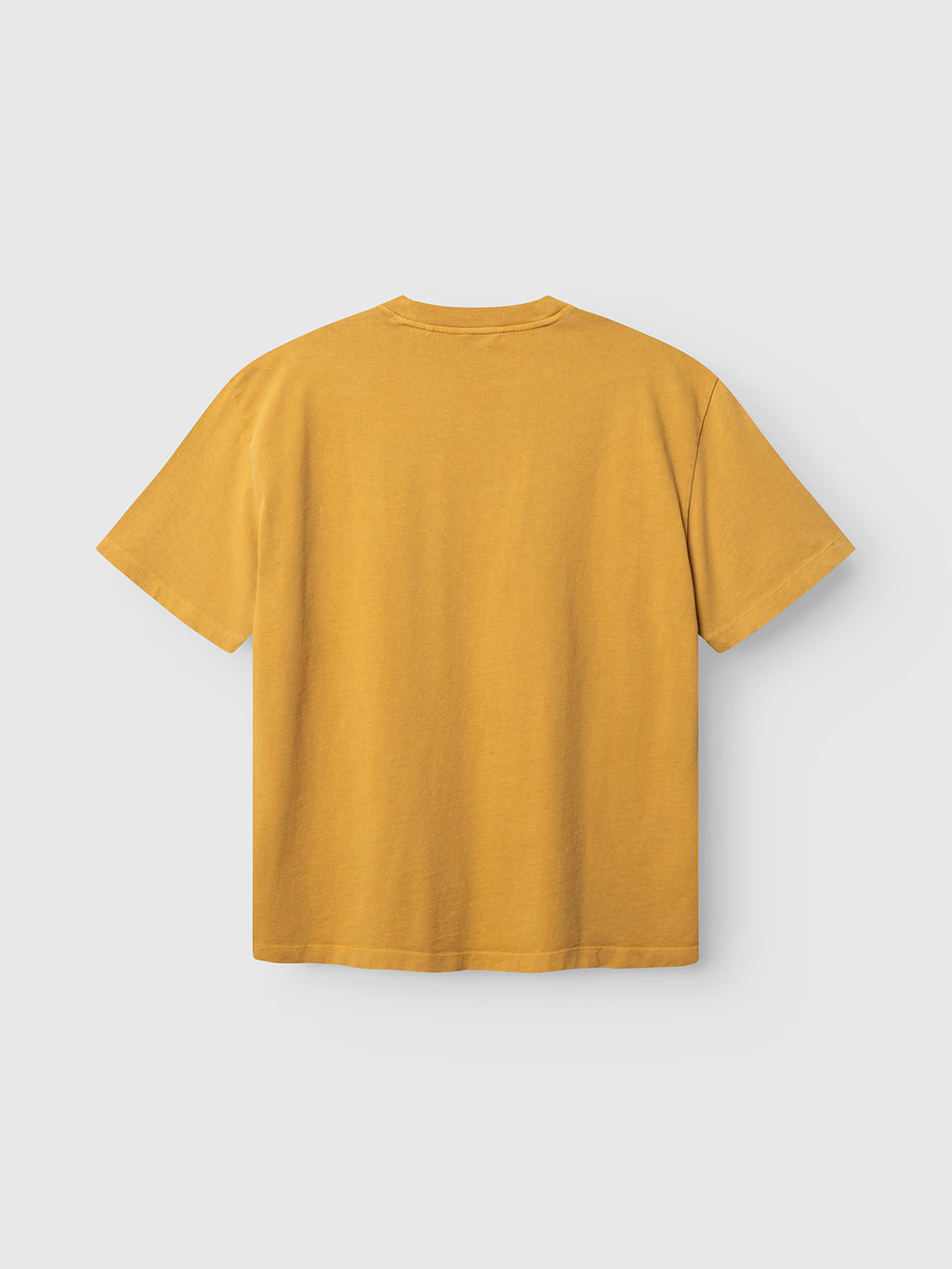 The Gabba GABnigel Wix Pkt Boxy Hour SS T-Shirt in mustard yellow, crafted from heavyweight cotton, is displayed laid flat on a white background with the back side visible.