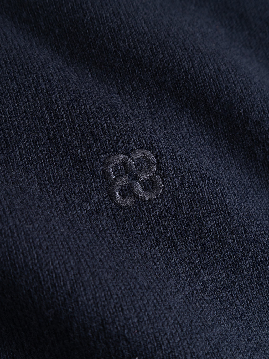 Close-up of a navy GABfumo Element Spy LS Knit in flat-knit cotton with an embroidered tonal logo.