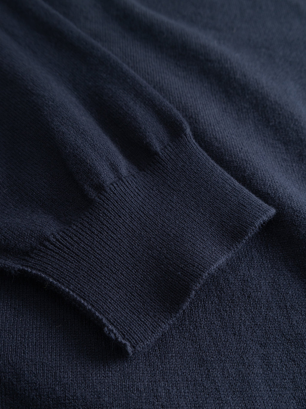 Close-up of a navy GABfumo Element Spy LS Knit, showing the ribbed cuff detail of the flat-knit cotton.