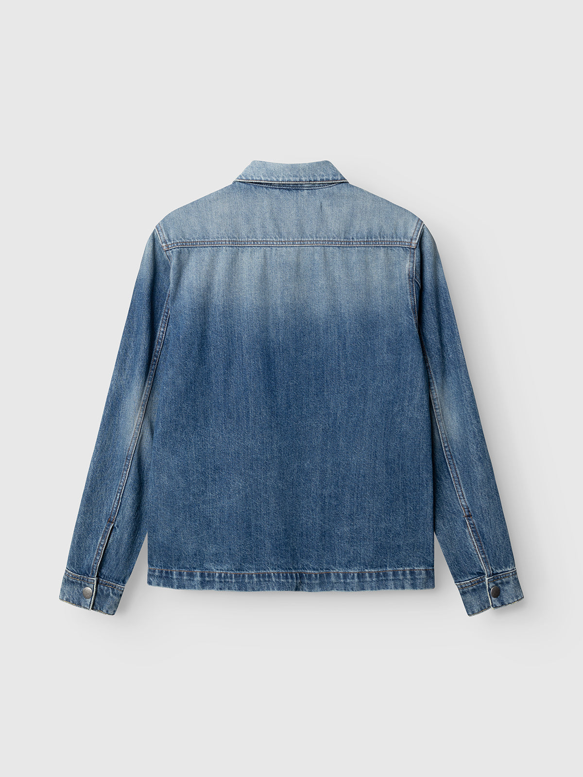 A back view of the Gabba GABbeta Wolv DS0004 LS Overshirt in dark blue denim, crafted from cotton. This long-sleeve jacket presents a faded, slightly gradient laser-washed finish and features buttoned cuffs, creating a subtle workwear-inspired style with no visible branding or embellishments.