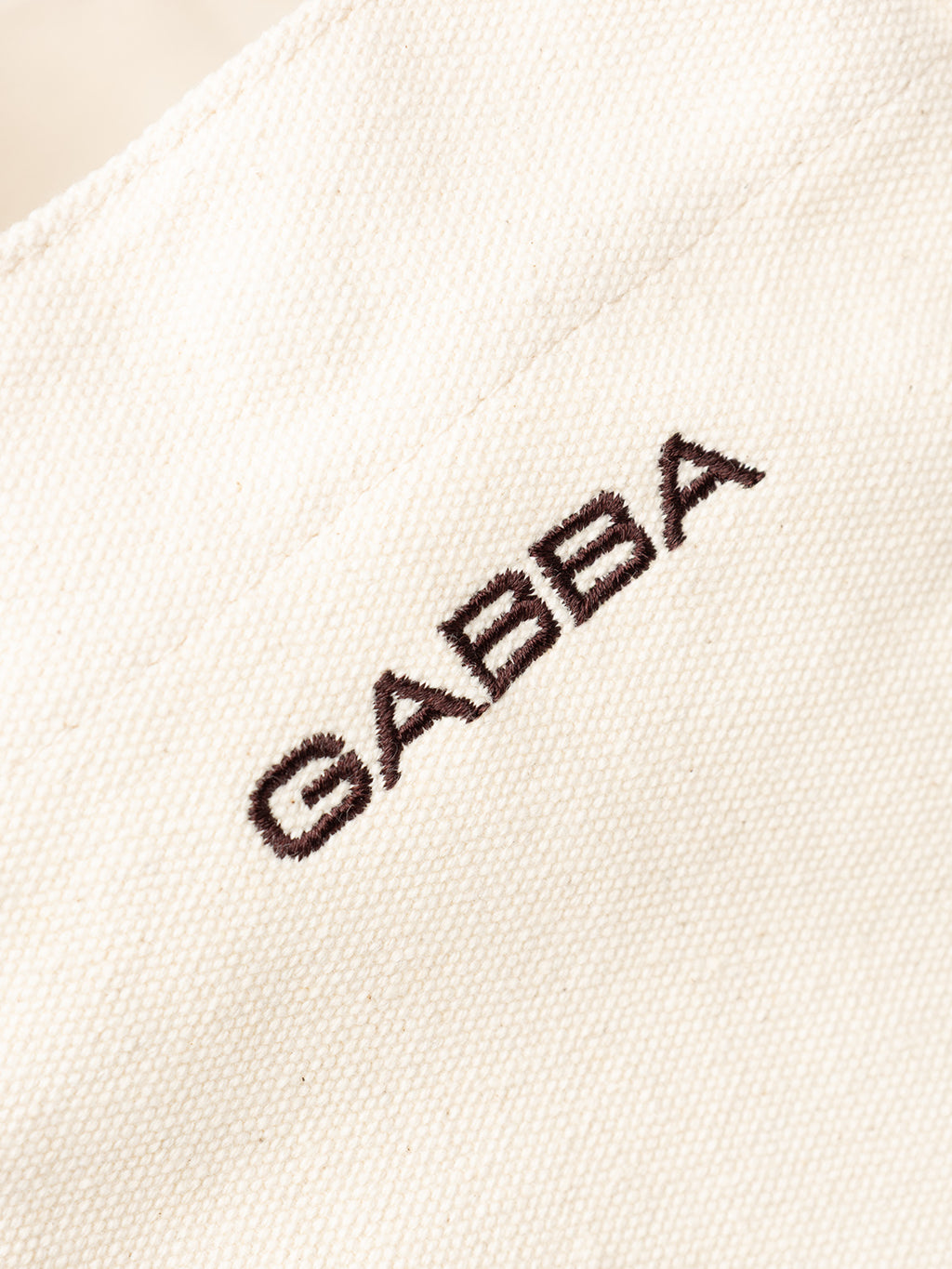 Close-up of the GABchap Tote Bag - Off White by Gabba, showing off-white fabric with 