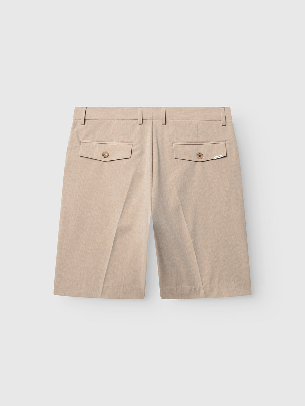 The GABjoli Tailor Dressy Shorts by Gabba in Sand are knee-length, shown from the back, with two flap pockets featuring button closures and subtle stitching details.
