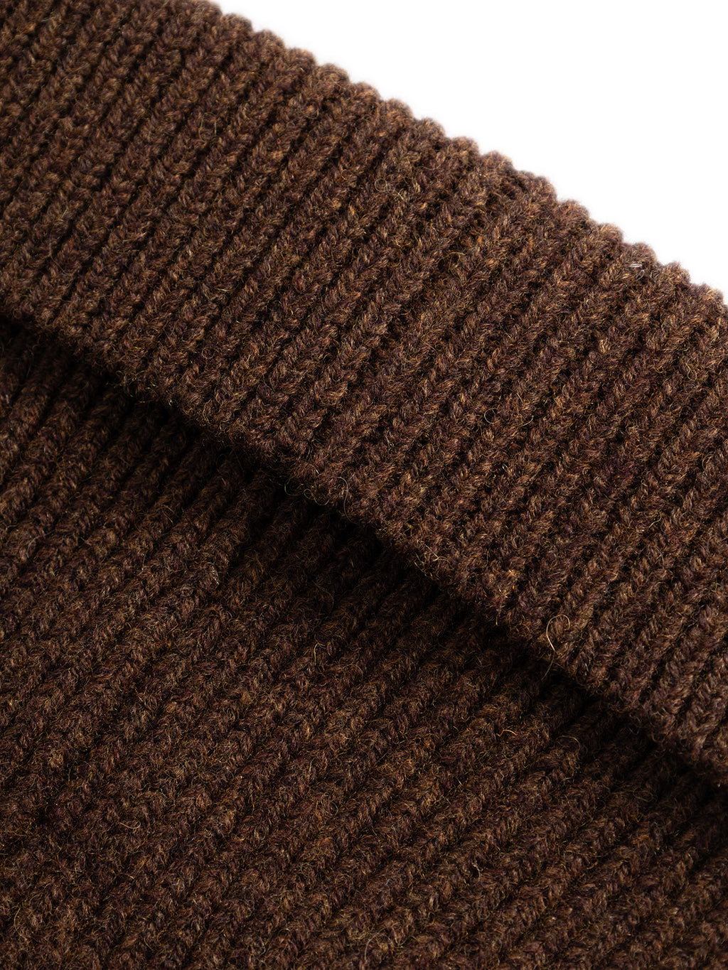 Close-up of the thick, ribbed brown knitted fabric of the Gabba GABeast Flash Beanie in Brown Slate, highlighting its texture and stitching details in a folded section—perfect as a stylish winter accessory.