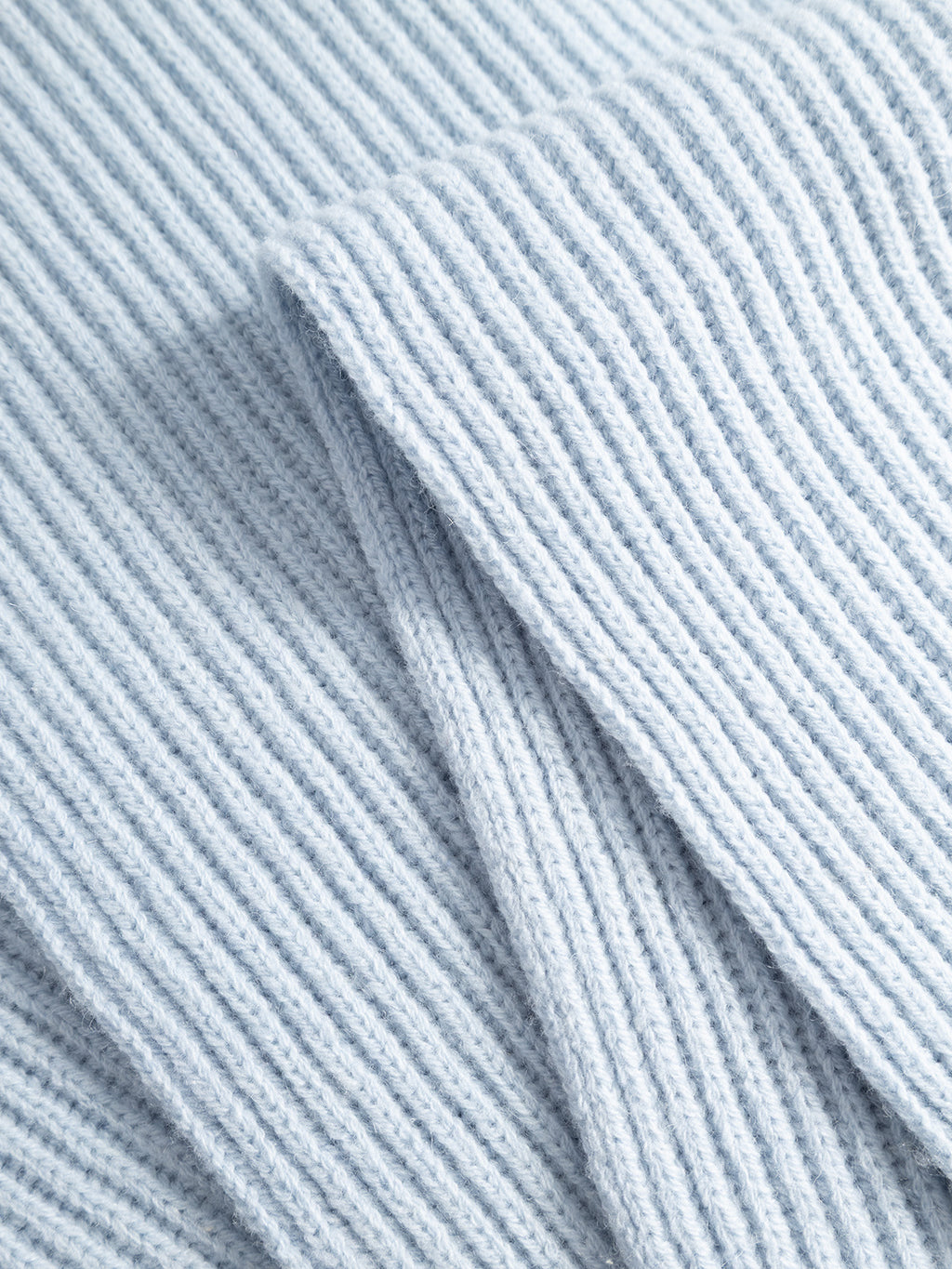 Close-up of the GABeast Flash Scarf in Dusty Blue by Gabba, folded to highlight its rib-knit texture and soft feel—a perfect winter accessory.