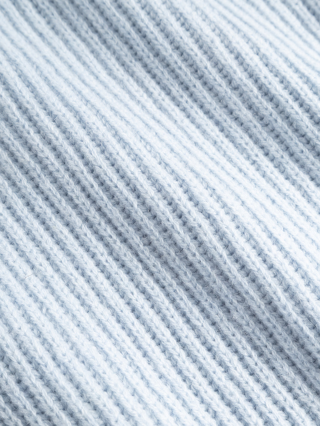 Close-up of the GABeast Flash Scarf in Dusty Blue by Gabba, featuring soft rib-knit fabric with vertical textured lines and gentle folds that create a cozy, warm appearance—making it the perfect winter accessory.
