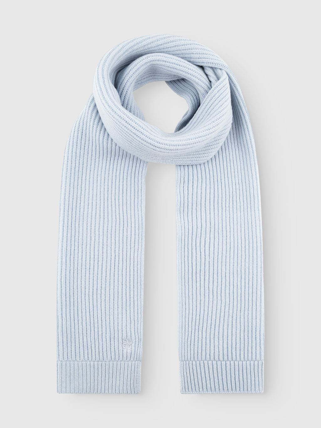 The GABeast Flash Scarf in Dusty Blue from Gabba is neatly folded in a loop shape on a plain white background, making it a stylish winter accessory.