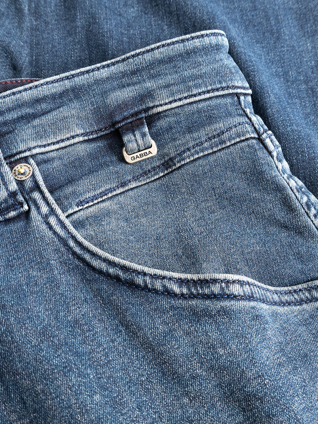Close-up of the GABalex Cropped Nham RS2113 Jeans in dark blue denim, showcasing a front pocket, visible stitching, and a small metal tag with the Gabba brand name. Made from performance comfort ISKO denim in a deep blue wash, these jeans feature a relaxed tapered fit for modern style and ease of movement.