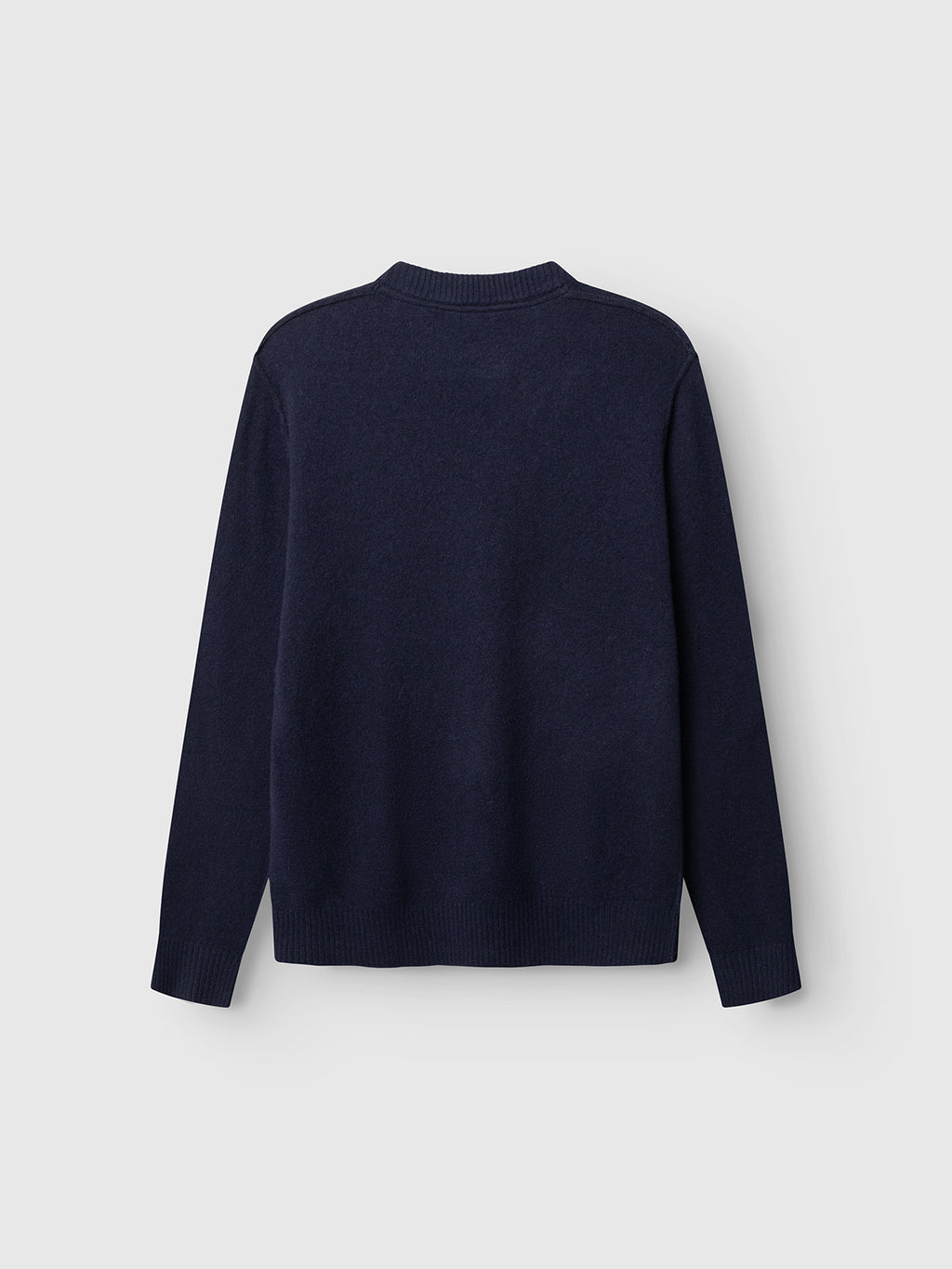 The Gabba GABtokota Element Aico LS Knit in navy is displayed flat against a light grey background, showcasing the back of the long-sleeved crew neck sweater—an ideal choice for everyday comfort.