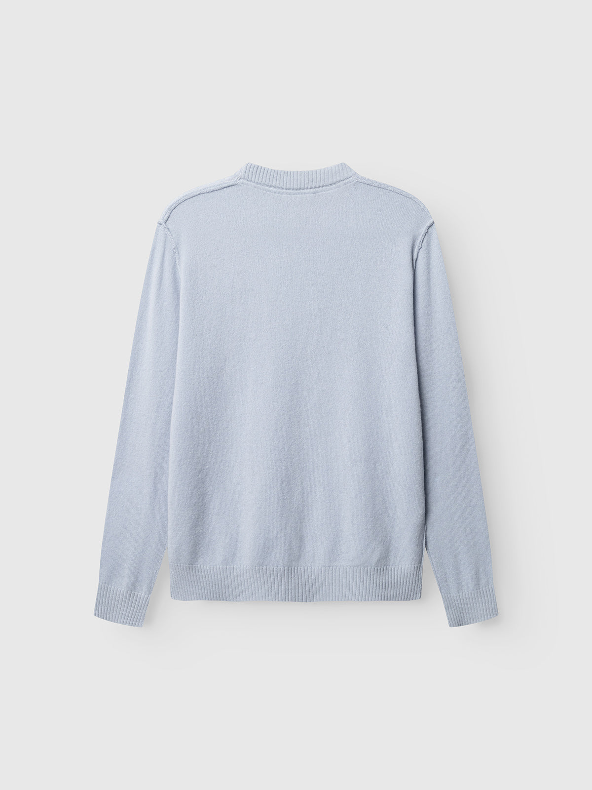 The Gabba GABtokota Element Aico LS Knit in Dusty Blue is displayed laid flat with the back facing up against a plain white background. Crafted for everyday comfort, this soft wool sweater features long sleeves, a crew neck, and ribbed cuffs and hem.