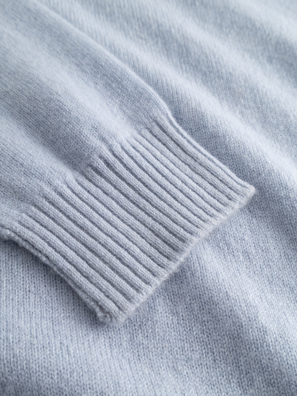 Close-up of the Gabba GABtokota Element Aico LS Knit sweater in Dusty Blue, highlighting the soft, textured fabric and ribbed cuff—designed for everyday comfort.