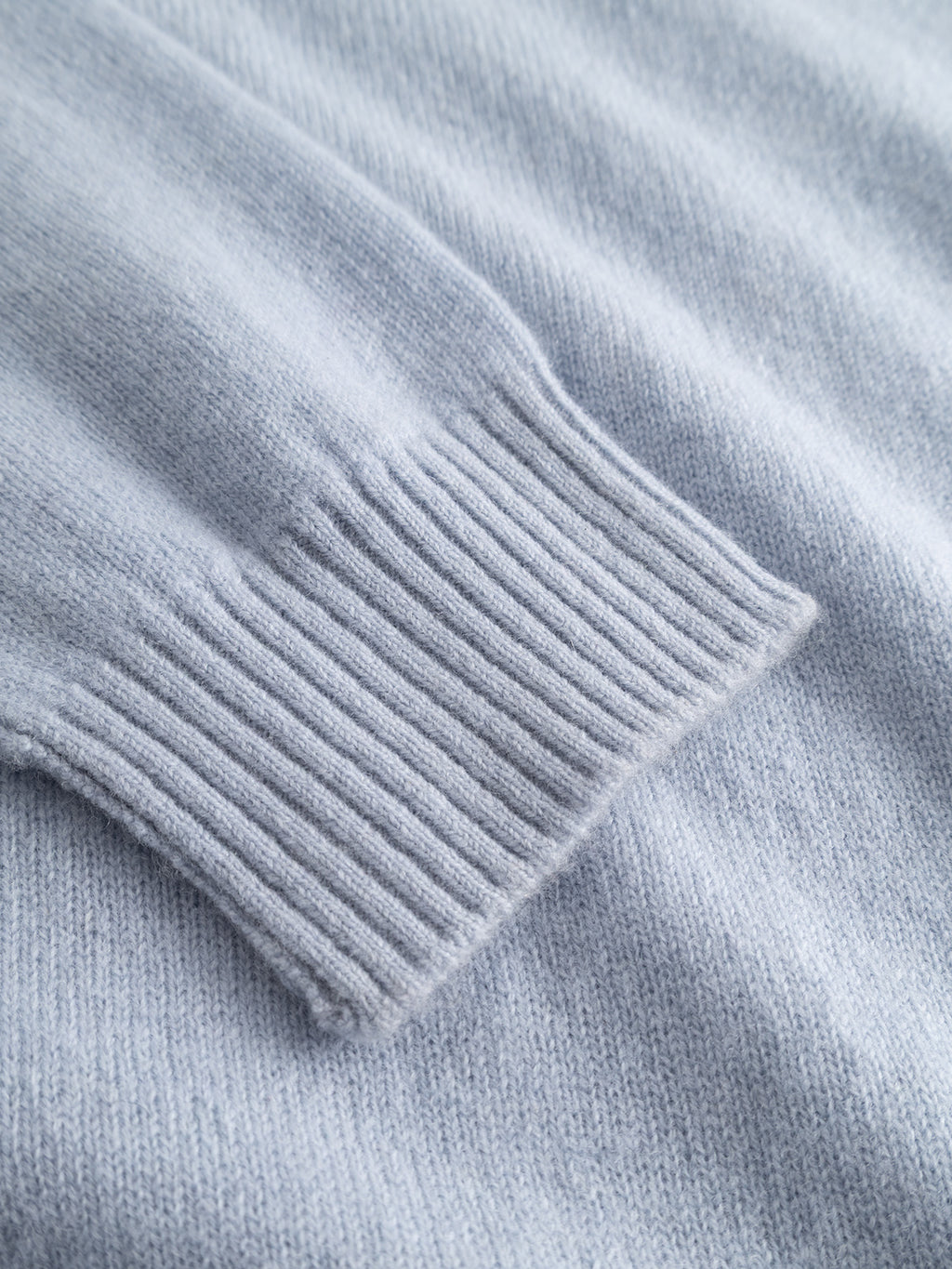 Close-up of the Gabba GABtokota Element Aico LS Knit sweater in Dusty Blue, highlighting the soft, textured fabric and ribbed cuff—designed for everyday comfort.