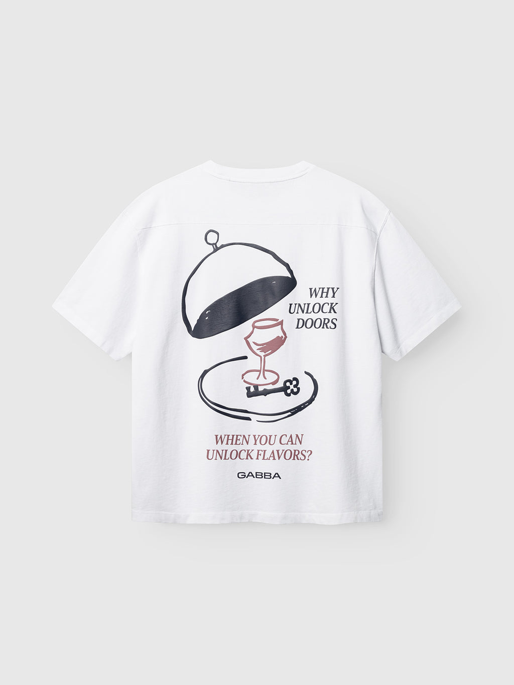 The GABlegin Wix Boxy Hour Lobby2 SS T-shirt by Gabba is crafted from textured white cotton jersey in a relaxed, boxy fit, featuring a bold front graphic of a wine glass beneath a cloche. The shirt displays the text “WHY UNLOCK DOORS WHEN YOU CAN UNLOCK FLAVORS?” with Gabba printed at the bottom.