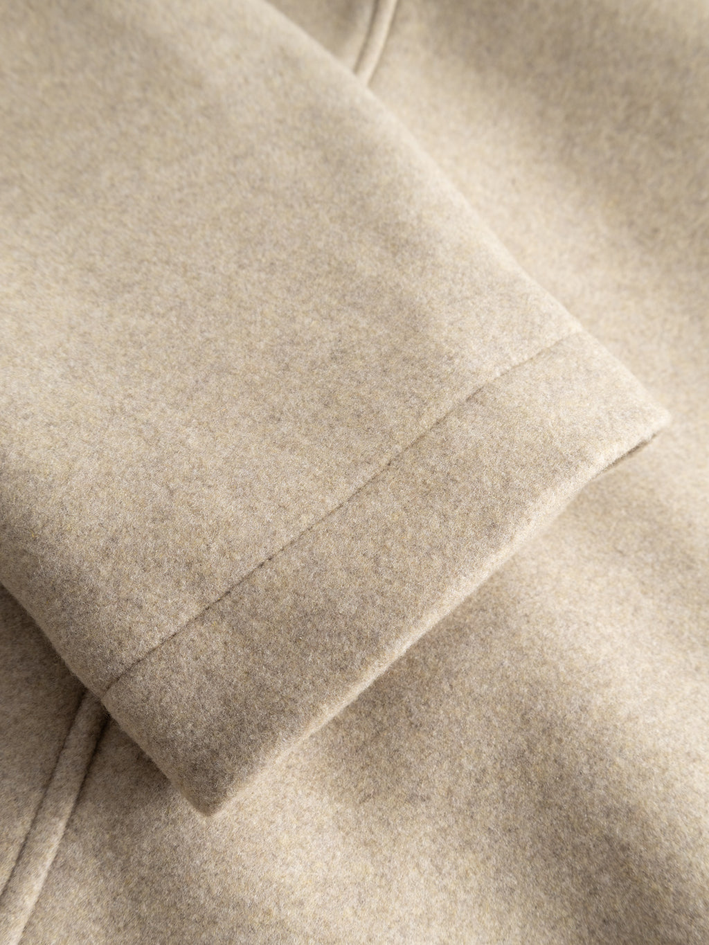 Close-up of the GABmatheo Plain Bomber Jacket in Sand by Gabba, highlighting the soft, wool-inspired fabric and precise seam detailing on the cuff—a refined yet casual outerwear choice for style-conscious individuals.