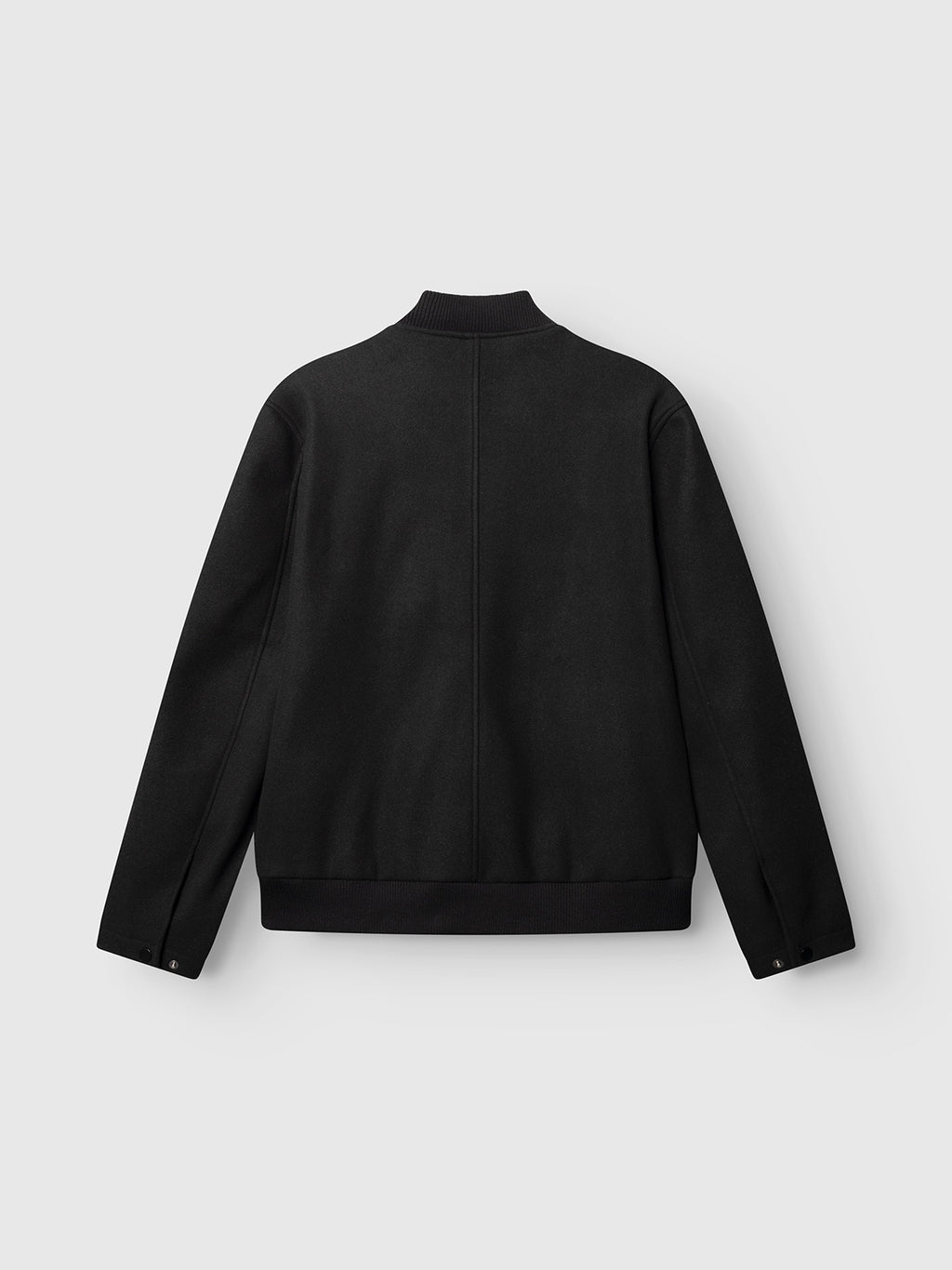 The GABmatheo Plain Bomber Jacket by Gabba is displayed laid flat and photographed from the back on a light gray background. Crafted from a wool-inspired fabric, this black casual outer layer features a ribbed collar, cuffs, and waistband, with long sleeves and no visible design or embellishments.