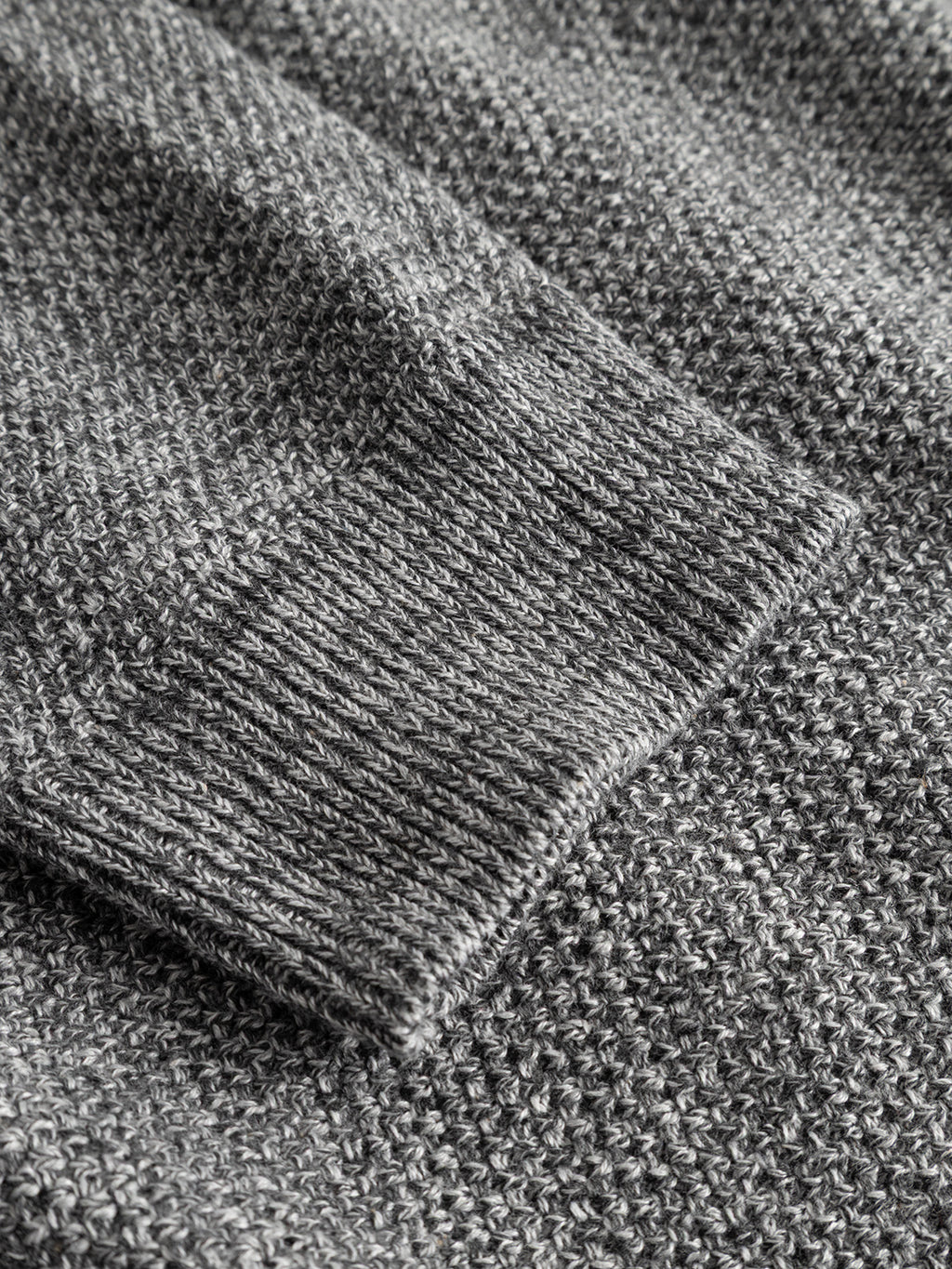 Close-up of the GABlamix Coro O-Neck LS Knit in Lt. Grey from Gabba, highlighting the textured cotton-blend fabric and the ribbed cuff of the crew neck sleeve.