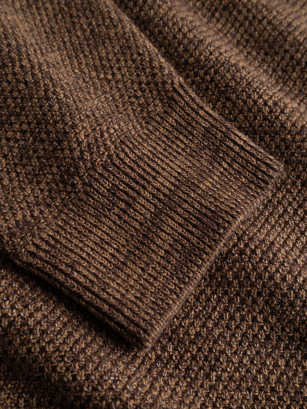 Close-up of the GABlamix Coro Jhon LS Knit sweater sleeve in Brown Slate by Gabba, highlighting the detailed ribbed cuff texture, intricate knit weave pattern, and a subtle Gabba brand mark.