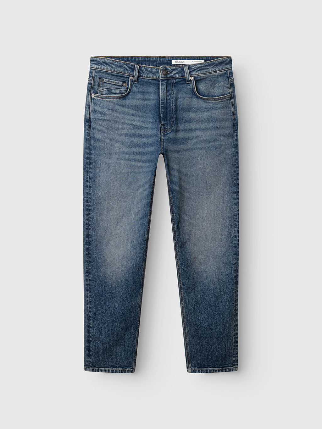 The GABmarc Silvi DS0007 Jeans by Gabba feature a classic five-pocket design and subtle thigh fading, crafted from comfort stretch denim in a mid blue wash. These regular fit jeans have a straight leg cut and are displayed laid flat against a neutral gray background.
