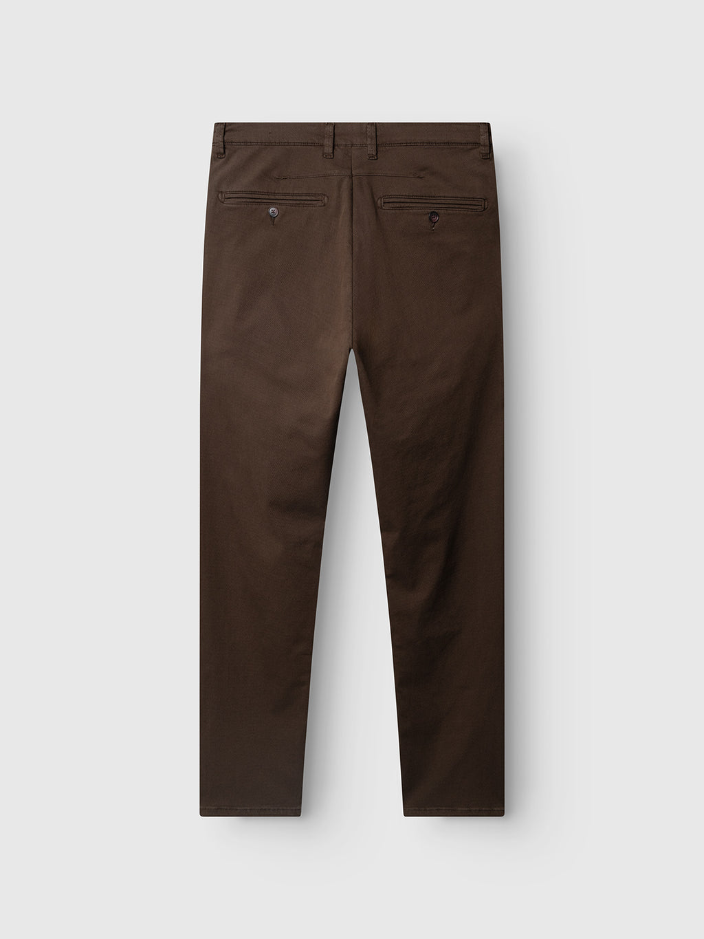 The Gabba GABpaul K3280 Dale Chino in Brown Slate is shown from the back, highlighting its two rear buttoned welt pockets, belt loops, and a straight-leg slim fit. Crafted from a high-stretch cotton-blend fabric for comfortable everyday wear, these dress pants are set against a light background.