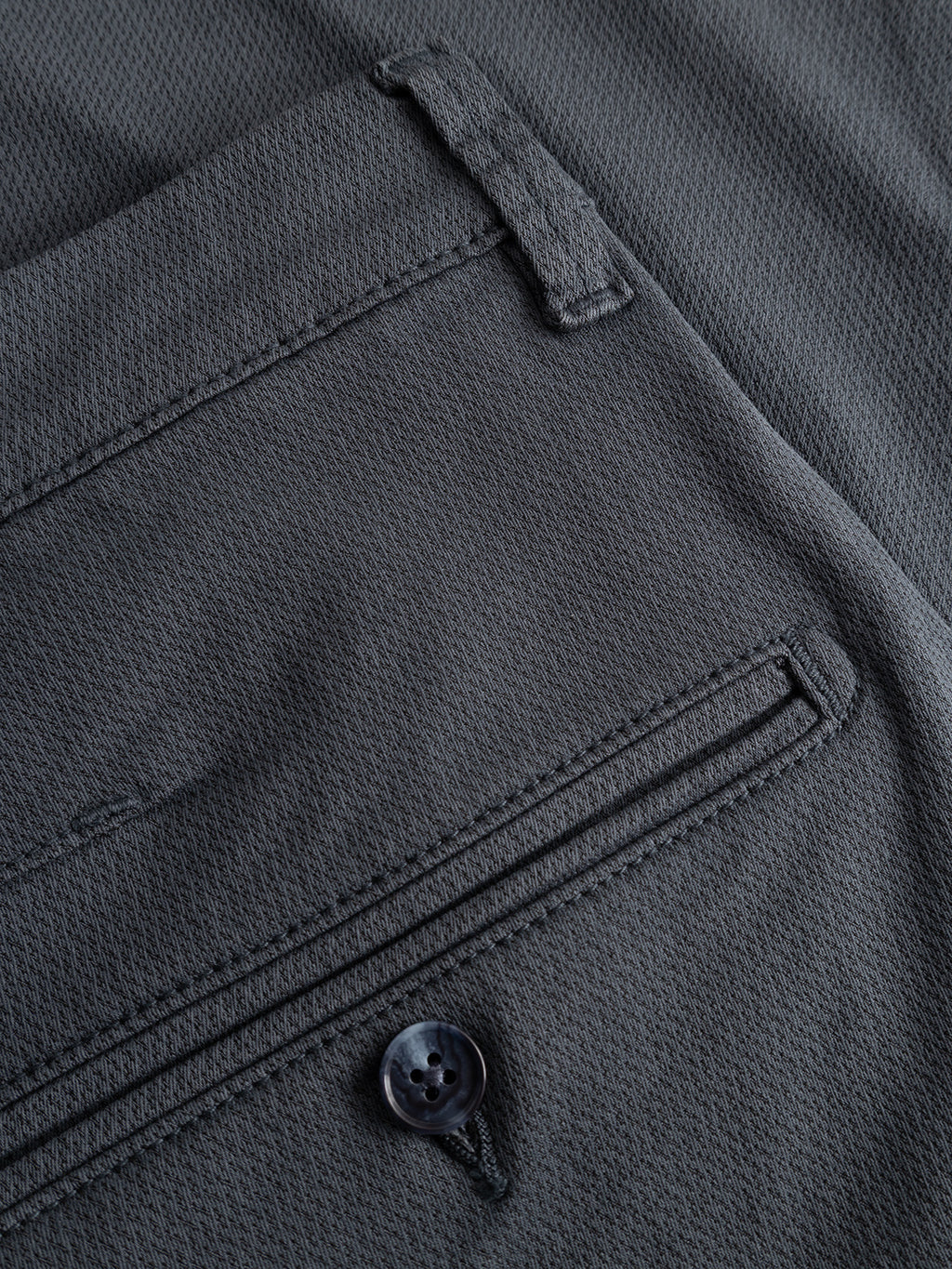 Close-up of the back pocket of the Gabba GABpaul K3280 Dale Chino in Turbulence Blue, featuring a button closure, textured fabric, and classic French pockets.