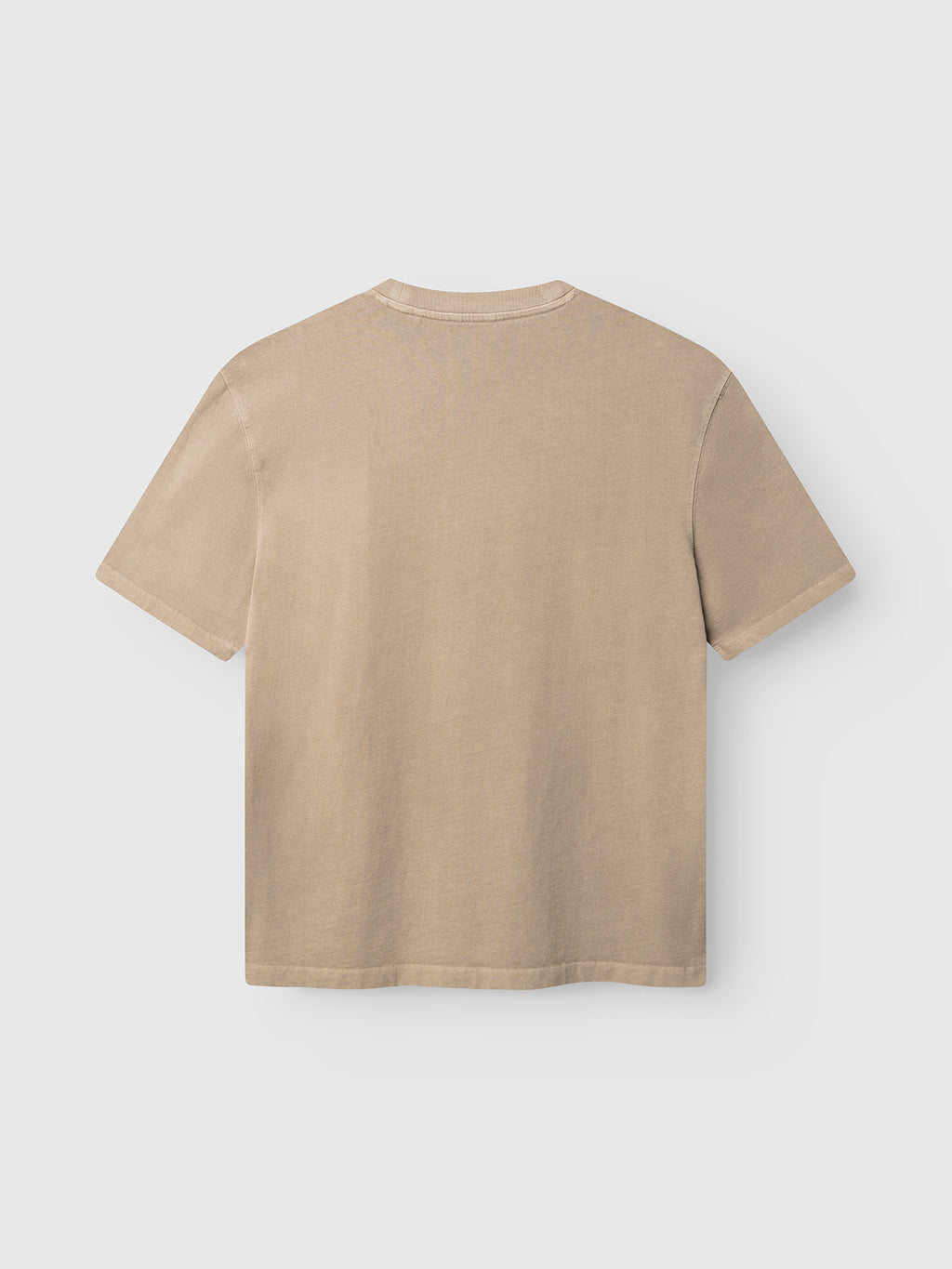 The Gabba GABlegin Wix Boxy Hour SS T-shirt in Sand Crocker is displayed from the back, laid flat on a light gray background. Made from mid-weight cotton jersey, this short-sleeve shirt features a simple, unadorned design with no visible logos or embellishments.