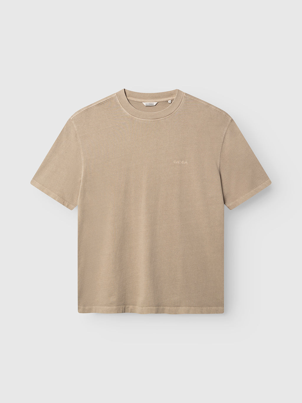 The Gabba GABlegin Wix Boxy Hour SS T-shirt in Sand Crocker showcases short sleeves and a crewneck, crafted from mid-weight cotton jersey in a relaxed boxy fit with subtle stitching and an embroidered Gabba logo, displayed against a plain light gray background.