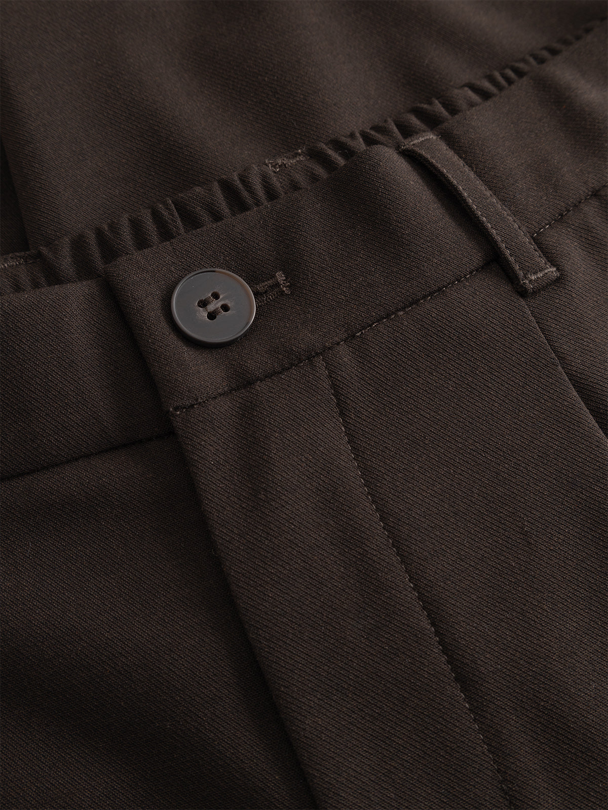 Close-up of the waistband and button on the Gabba GABnapoli 19 Phin GRS - Brown Slate wool blend chinos, highlighting stitching details, a belt loop, and an elastic section at the back.