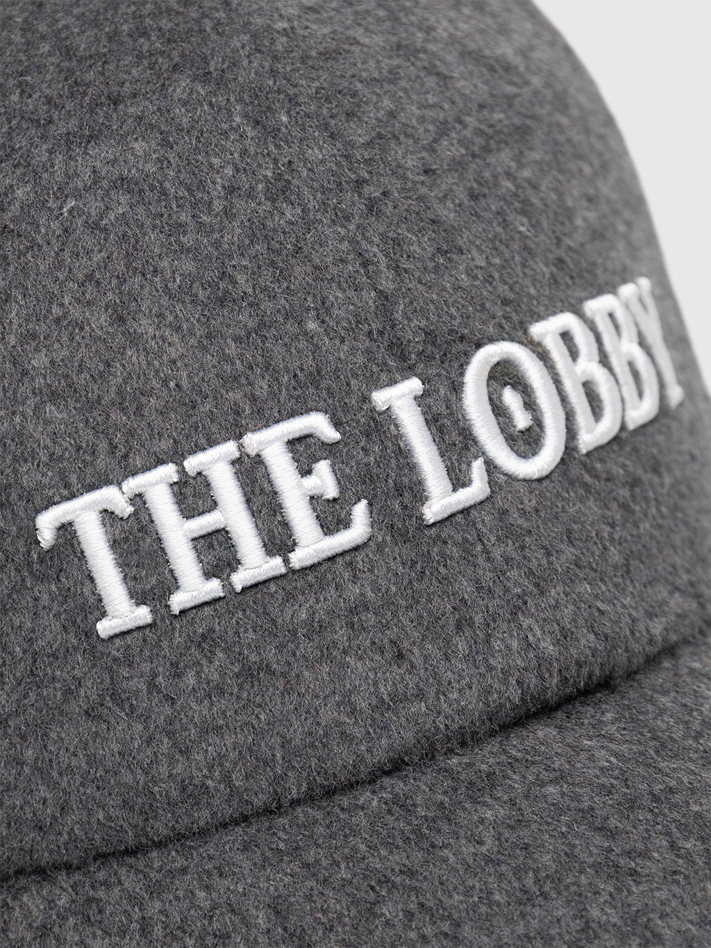 A close-up of the Gabba GABlimo W Lobby Cap in Grey Mel, featuring “THE LOBBY” embroidered in white capital letters and showcasing detailed embroidery craftsmanship.
