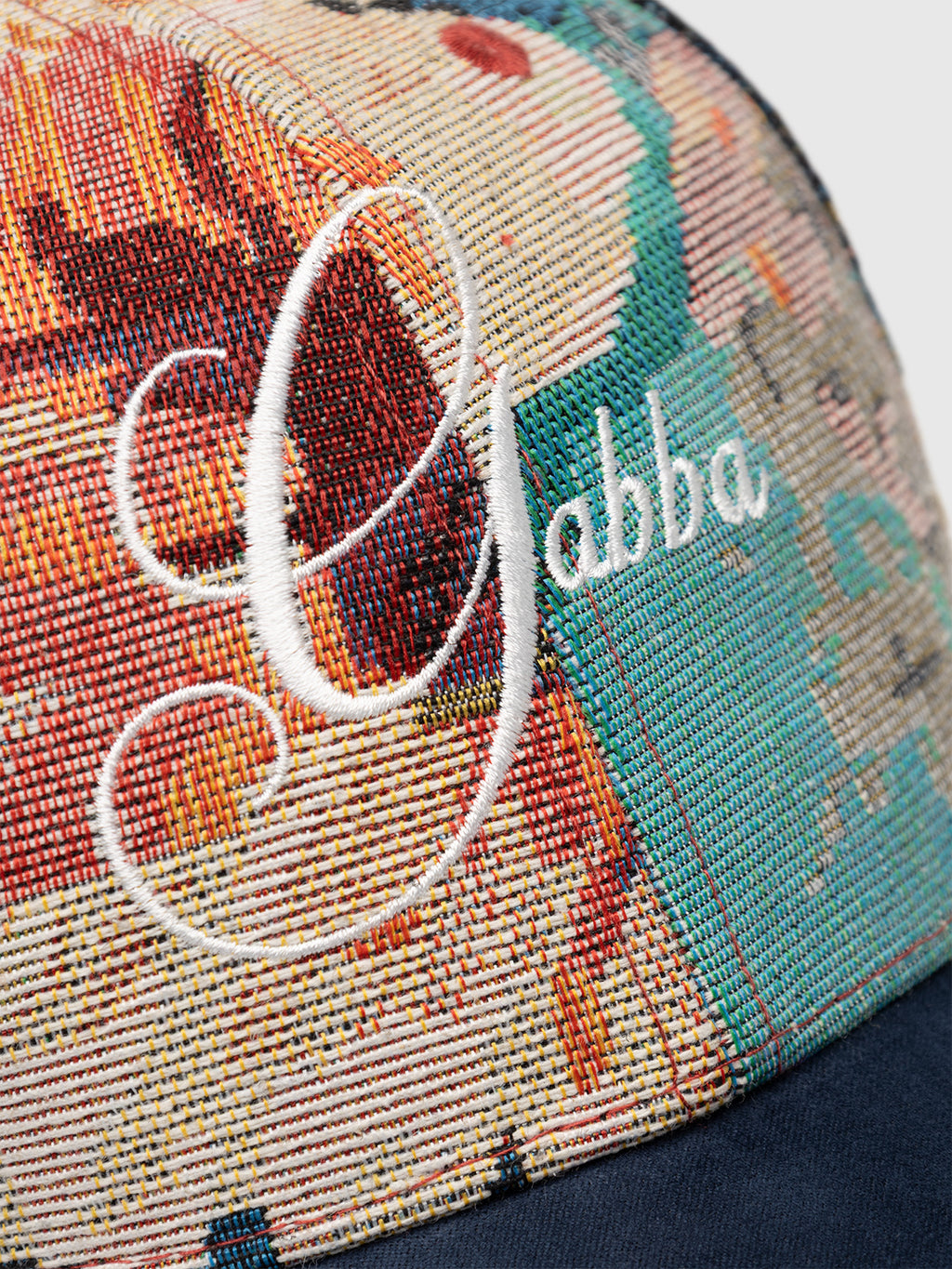 Close-up of the GABrichi Fiore Cap - Multi Pattern by Gabba, showcasing a vibrant jacquard design and “Gabba” embroidered in white cursive lettering on the front, complete with an adjustable back strap for a comfortable fit.