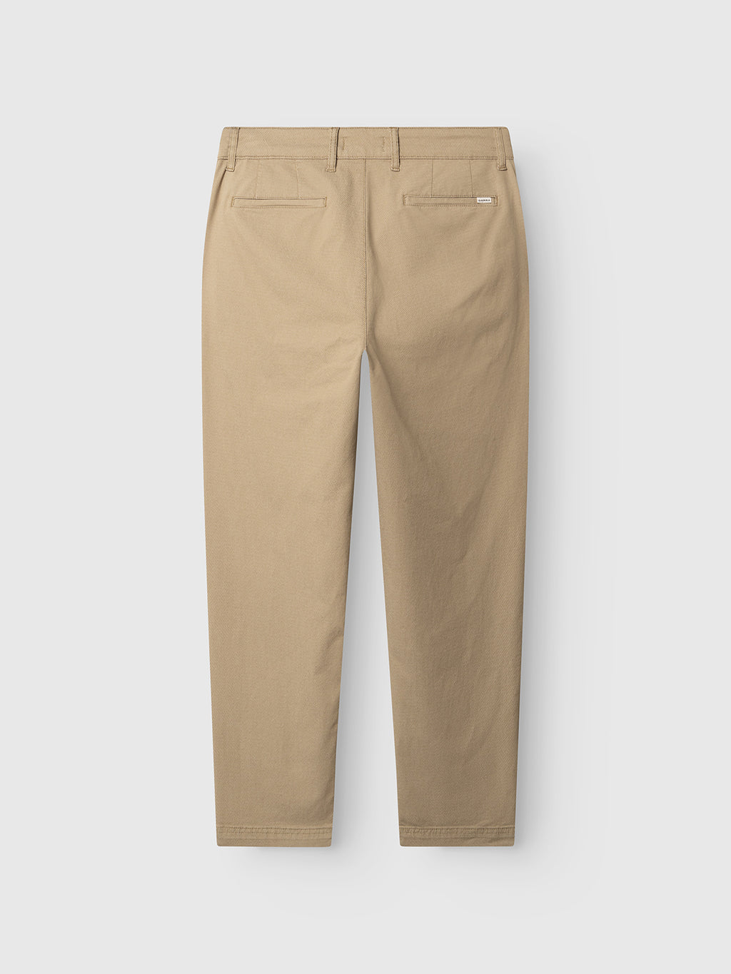 Back view of the Gabba GABjoe Nopleats Dale Pant in sand, featuring a high-stretch cotton blend, tapered fit, two welt pockets, and a small rectangular label above the right pocket, shown against a white background.