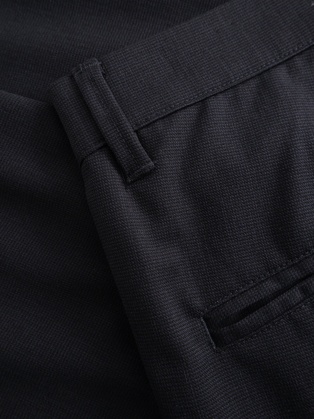 Close-up of dark navy micro-pattern woven fabric from the Gabba GABpaul Deme Pant, showing part of the slim-fit chino design with belt loop, waistband, and pocket details—ideal for everyday wear.