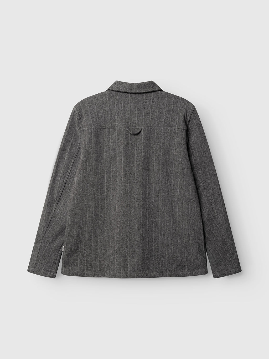 The GABlibre AX Stripes LS Overshirt by Gabba in dark grey is showcased from the back, displaying its boxy fit and subtle vertical pinstripes. The design features a collar and long sleeves, set against a plain light gray background.