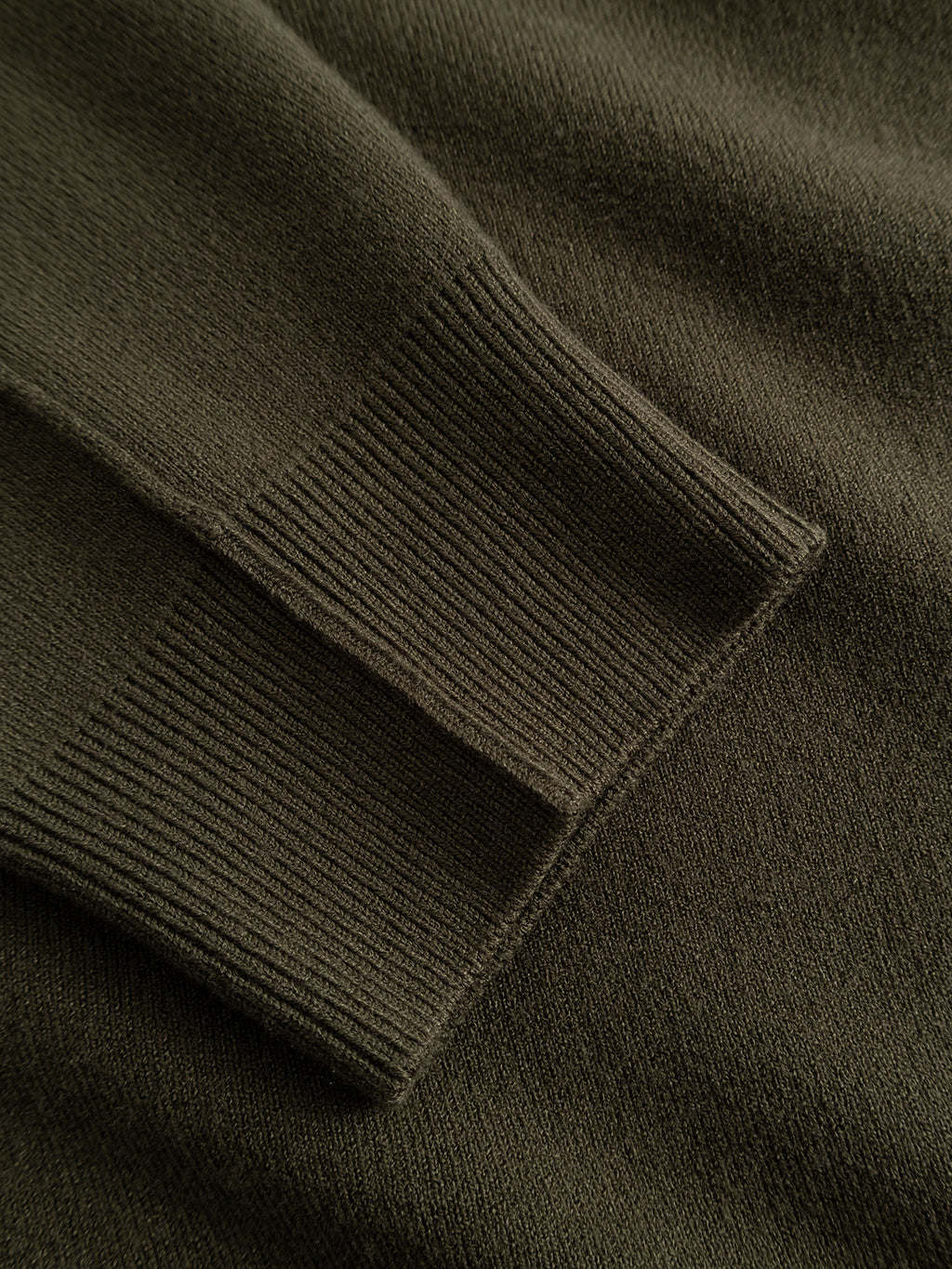 Close-up of the ribbed cuff of the Gabba GABadriel Zip Lume LS Knit in Forest Night, highlighting the texture and fine stitching detail of its viscose blend fabric.