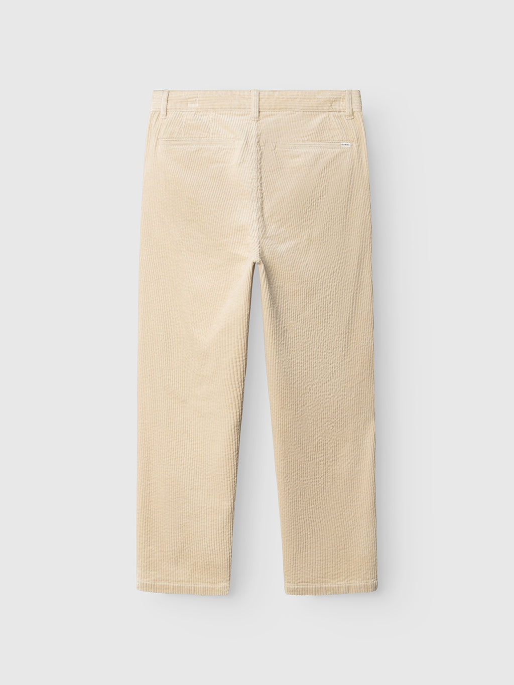 The GABjoe Nopleats Ibre Pant in Birch by Gabba is shown from the back, featuring classic chino construction with belt loops, two back welt pockets, and straight legs. Crafted from stretch corduroy, the pants are displayed against a plain light gray background.