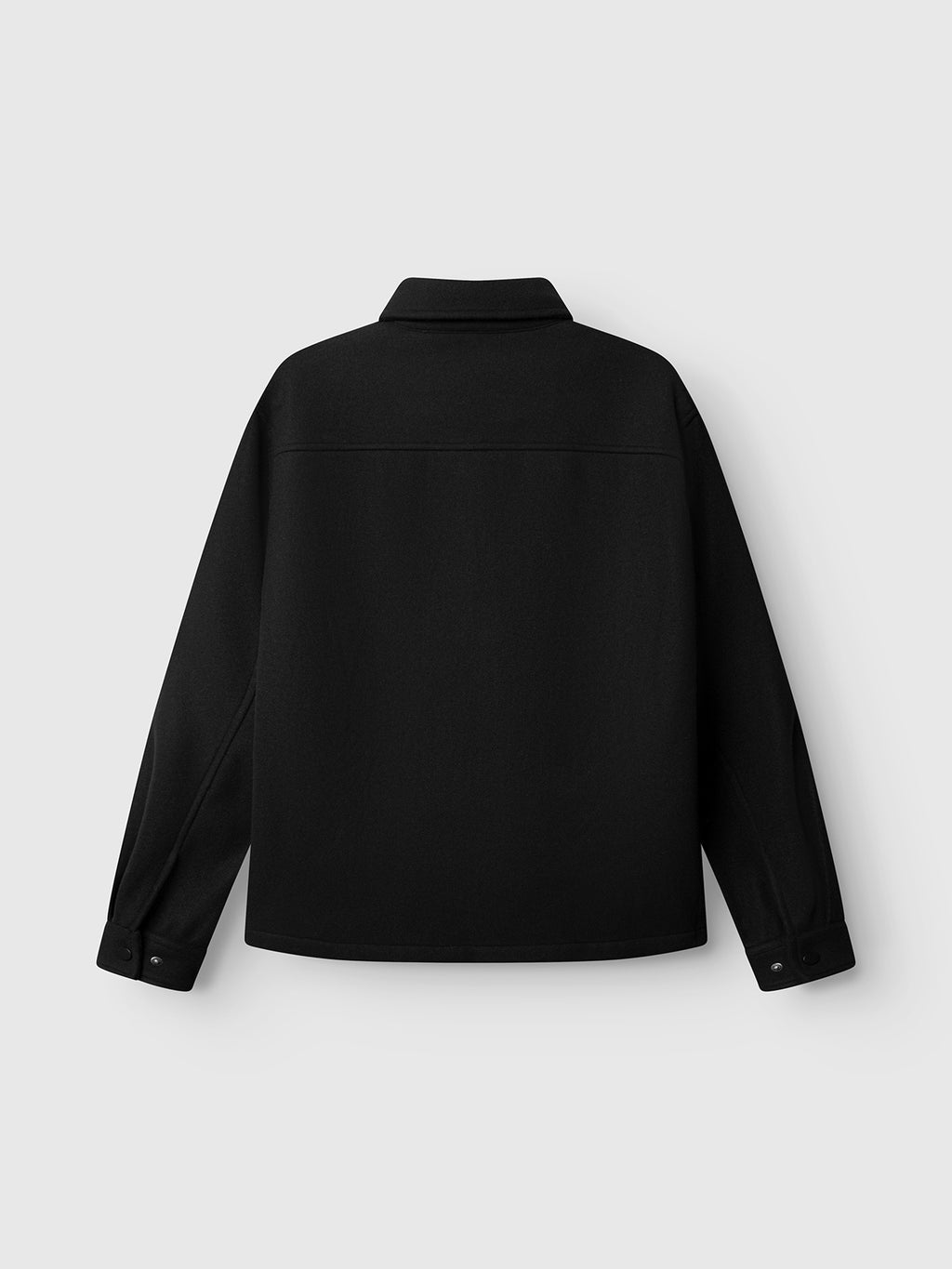 The GABtheo City Jacket by Gabba is shown from the back in black, featuring a straight hem, collar, and buttoned cuffs. Crafted from a wool-inspired fabric for everyday layering, it is displayed against a plain light gray background.