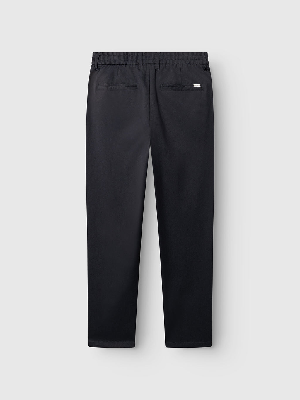 The Gabba GABmonza Tasca Deme Pant in dark navy features a relaxed straight fit, crafted from micro-patterned fabric with an elastic waistband and two back welt pockets, shown flat against a light gray background to display the back view.