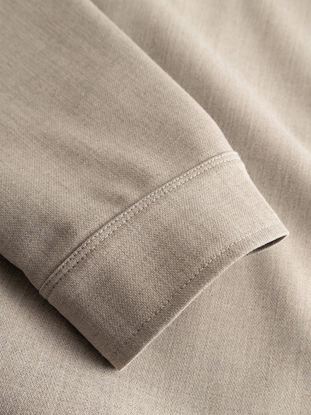 A close-up of the cuff on the Gabba GABtogger Push Phin LS Overshirt GRS in Sand highlights its precise stitching and soft wool-viscose blend—this stylish layering piece combines comfort with refined detail.
