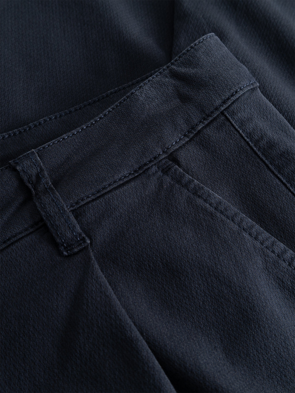 Close-up of the waistband, belt loop, and pocket of the Gabba GABjoe-pas Dale Pant in Blue Black, crafted from a high-stretch cotton-blend with tapered fit, highlighting detailed stitching and fabric texture for a refined contemporary silhouette.