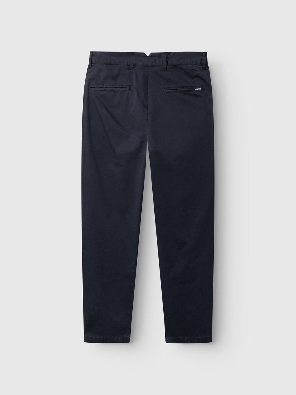 The GABfirenze Cropped Marlo Pant in Dark Navy by Gabba is displayed from the back against a plain white background, showcasing two rear welt pockets and a straight leg fit. Made from garment-dyed dobby fabric, these relaxed fit trousers deliver both style and comfort.