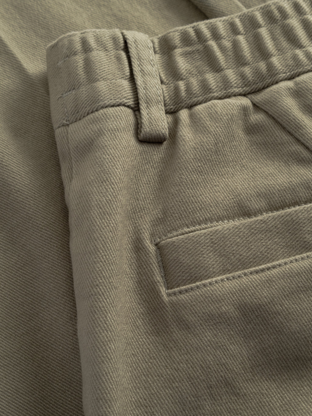 Close-up of the Gabba GABdenver Elastic Twill Pant in green, featuring a belt loop, elasticated waistband, side seam, back welt pocket, and crafted from stretch cotton twill.