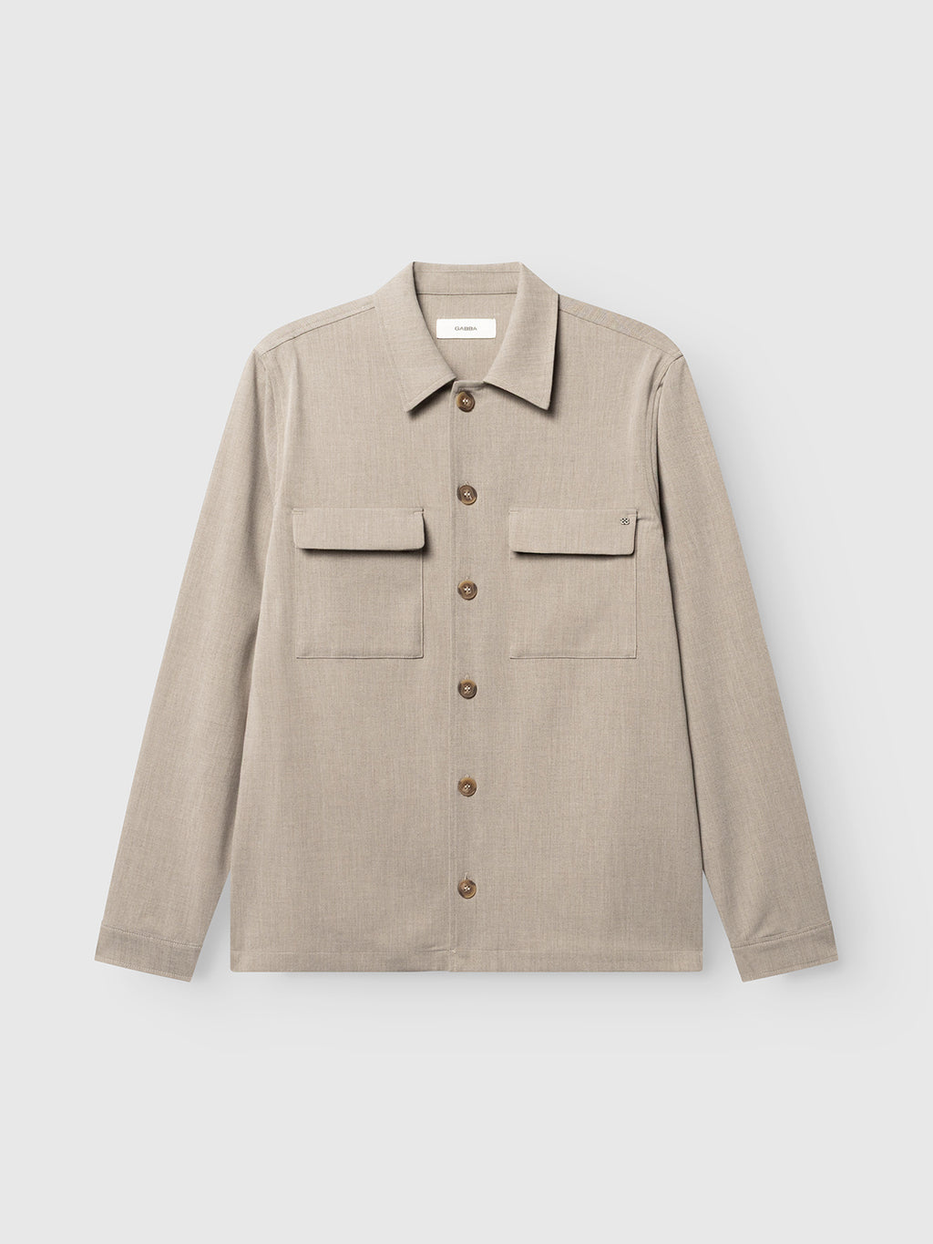 The Gabba GABtogger Push Phin LS Overshirt GRS in Sand is a regular-fit, light beige button-up shirt featuring a collar, long sleeves, and two front chest pockets. Crafted from a soft wool-viscose blend, this layering essential is laid flat on a plain white background.