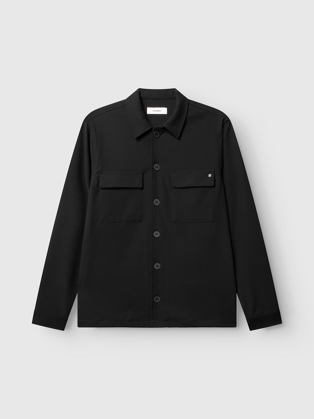The Gabba GABtogger Push Phin LS Overshirt GRS in black is a regular fit button-up shirt jacket featuring a classic collar and two front chest pockets. Crafted from a soft, durable wool-viscose blend, this versatile layering essential is shown against a plain light gray background.