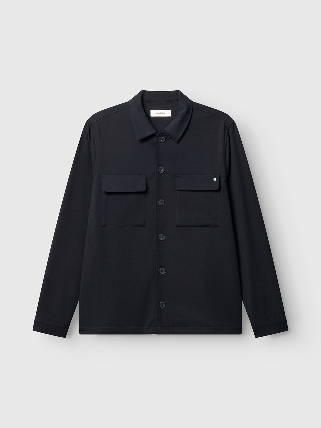 Introducing the GABtogger Push Phin LS Overshirt GRS - Blue Black by Gabba—a regular fit, button-up overshirt with a classic collar and two chest pockets. Crafted from a comfortable, soft wool-viscose blend, this wardrobe essential is showcased on a plain light gray background and offers versatile layering in timeless blue-black.